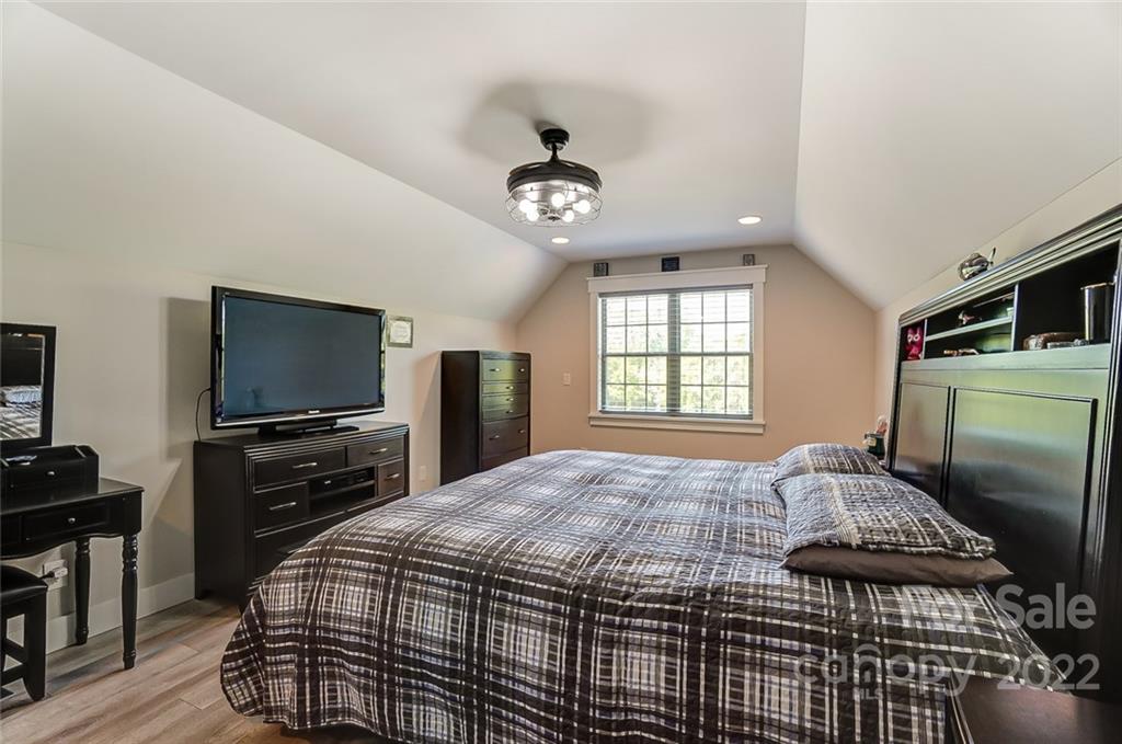 6250 Faith Road Salisbury, NC 28146 - Photo 23 of 38 a bedroom with a bed and a flat screen tv
