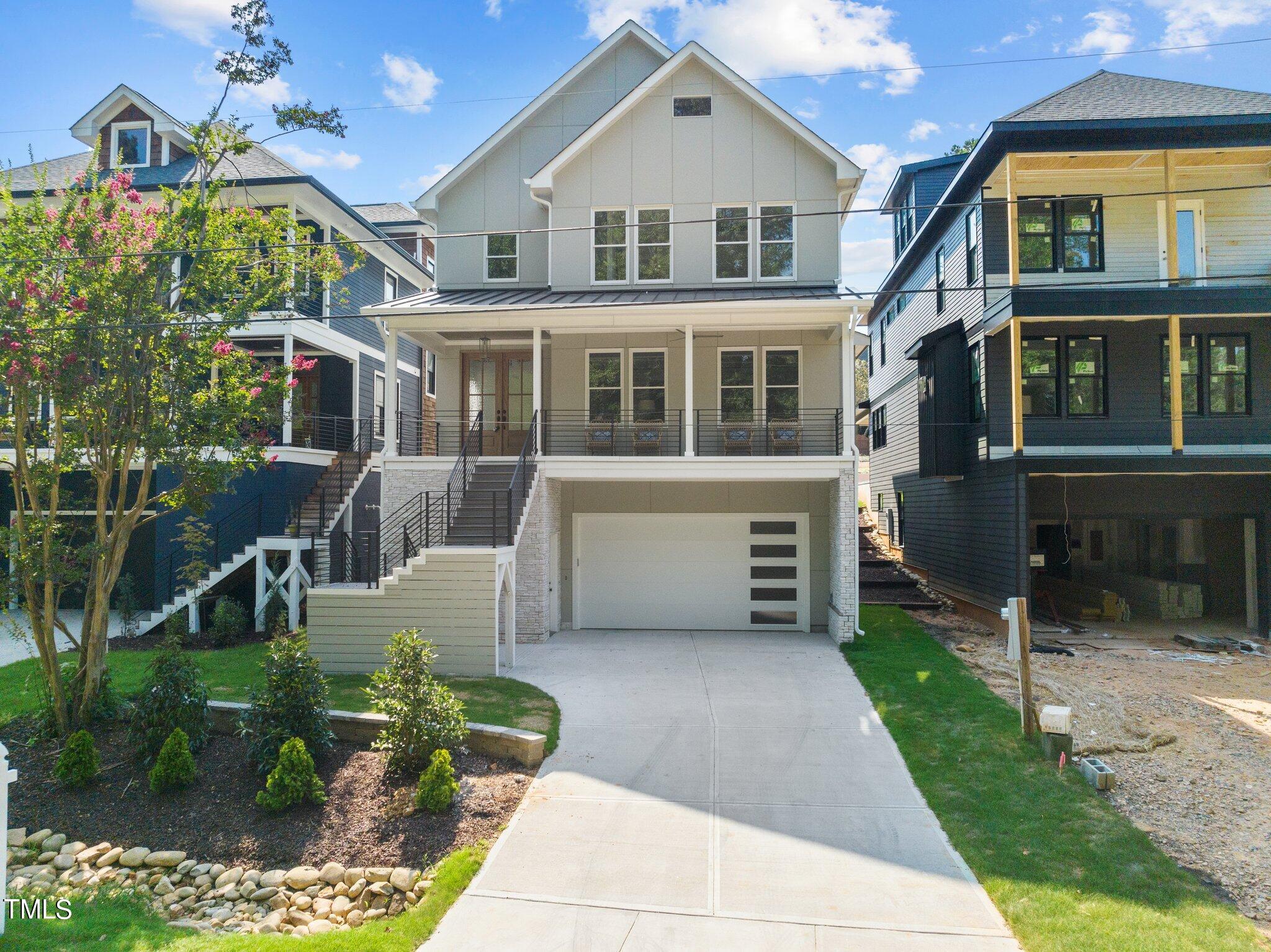 Exterior features include a beautiful staircase up to the main level, covered front porch, frost glass panels on the 2-car garage door, a screened porch, a large patio and a fenced yard.