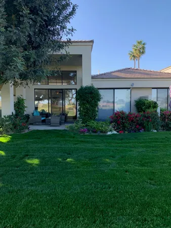 a front view of a house with garden