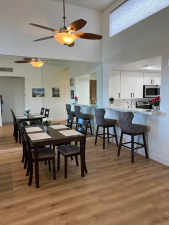 a view of a dining room with furniture and wooden floor