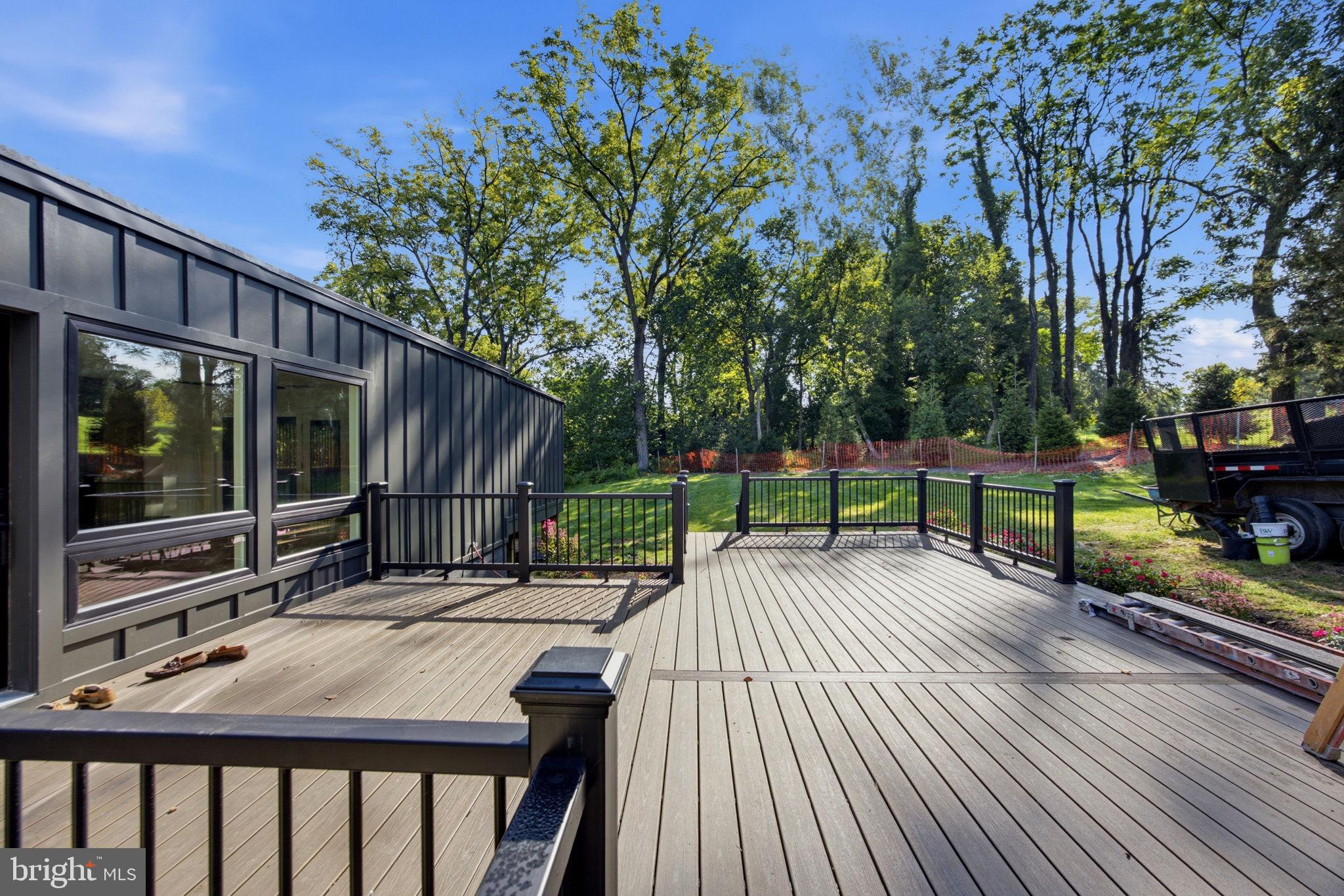 Serene deck with lush green backdrop.