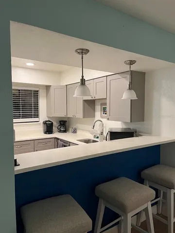 a kitchen with a stove and a chandelier