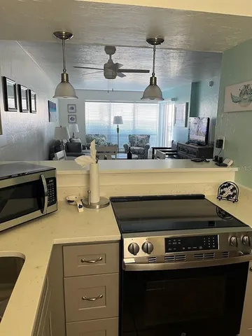 a view of a swimming pool with a patio and a yard
