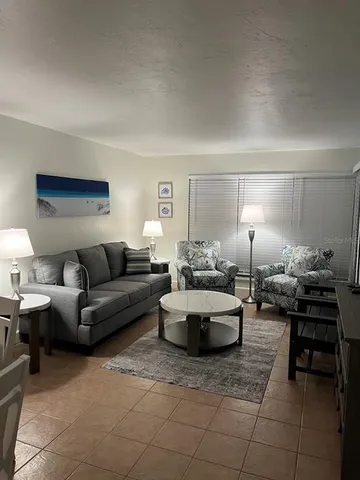 a living room with furniture and a piano