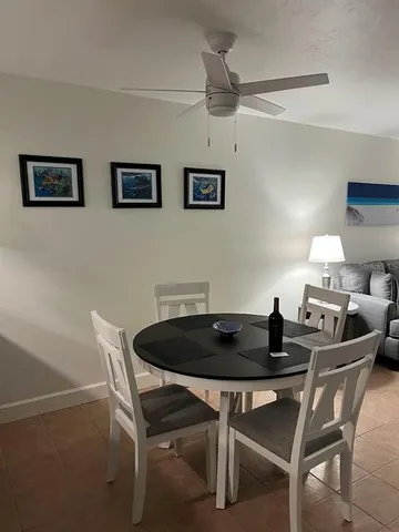 a dining room with a table chairs and chandelier
