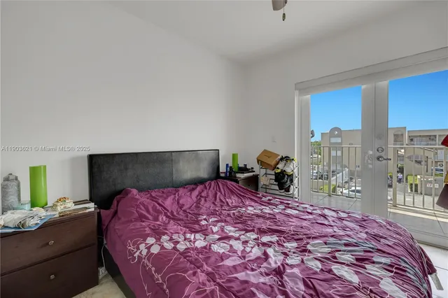 a bedroom with a large bed and a large window