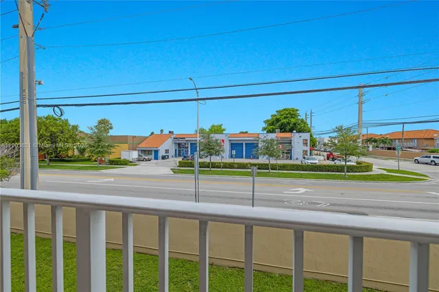a view of a street with cars parked