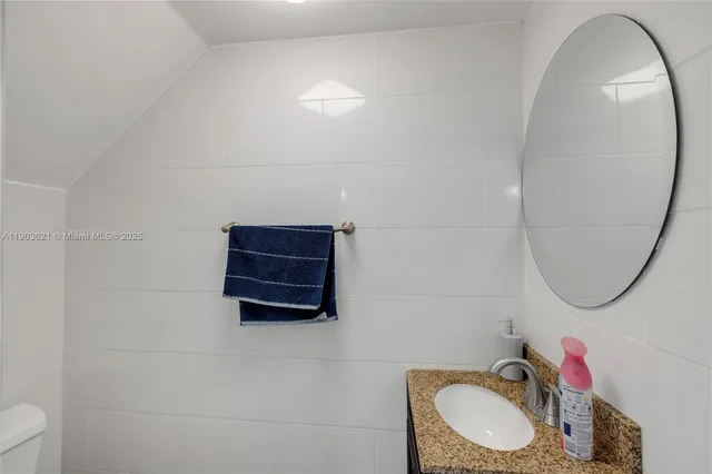 a bathroom with a sink a mirror and a toilet