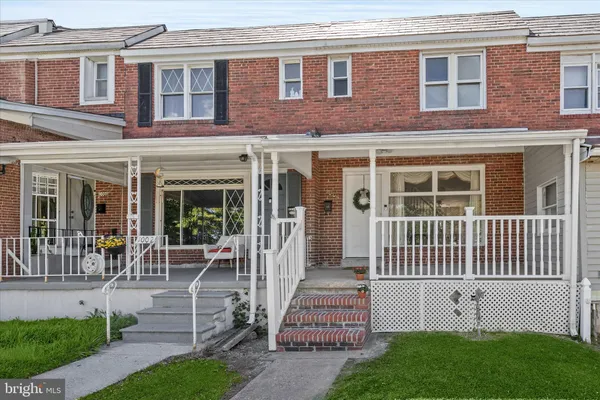 a front view of a house with porch and garden