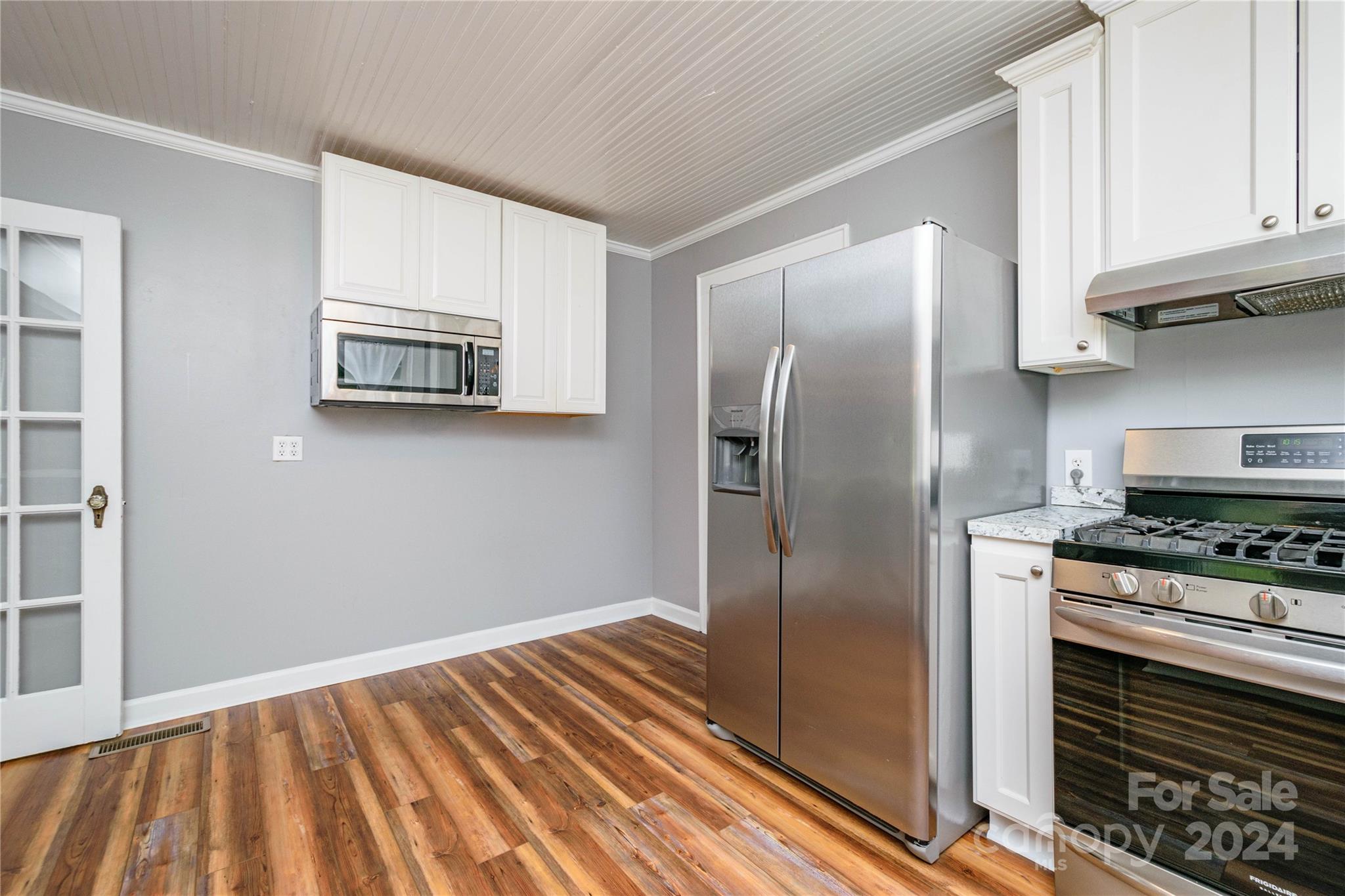 648 Chimney Rock Road Rutherfordton, NC 28139 - Photo 11 of 43 a kitchen with stainless steel appliances granite countertop a refrigerator a stove and a sink with wooden cabinets