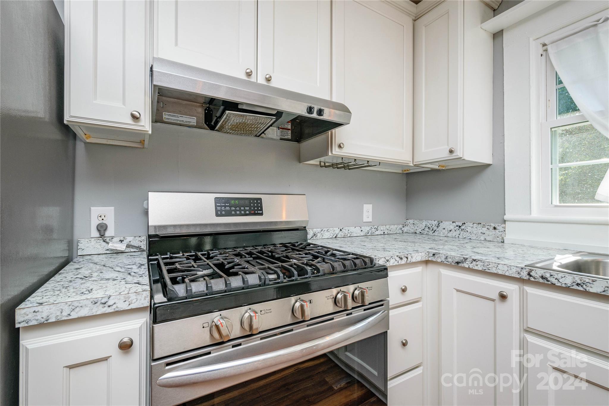 648 Chimney Rock Road Rutherfordton, NC 28139 - Photo 12 of 43 a kitchen with stainless steel appliances granite countertop white cabinets and a stove a oven with white countertops
