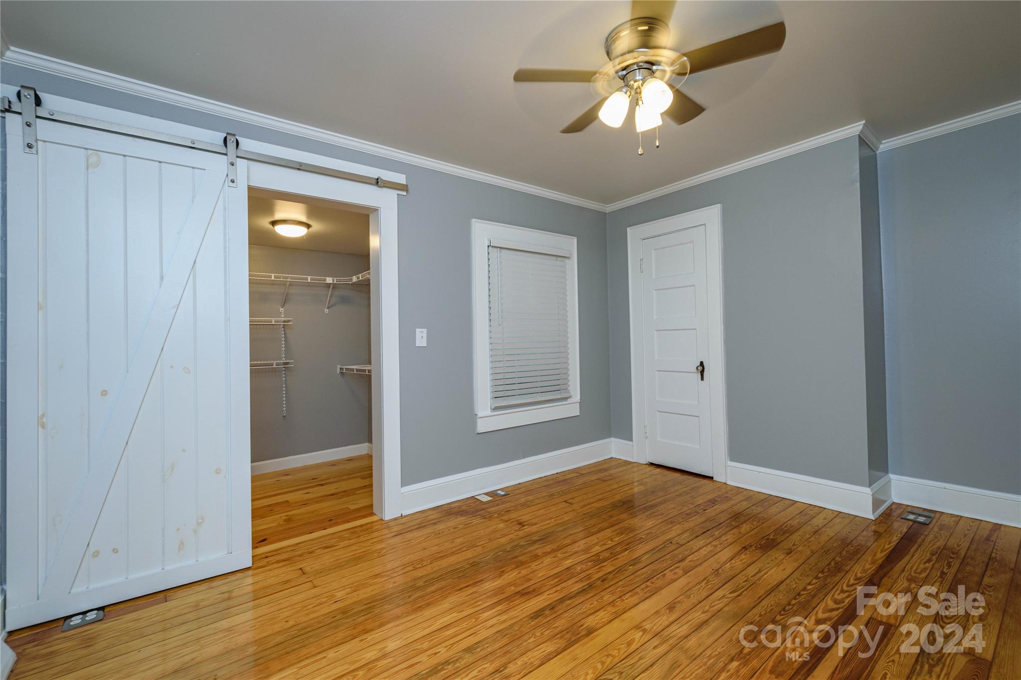 648 Chimney Rock Road Rutherfordton, NC 28139 - Photo 15 of 43 a view of a room with wooden floor and a ceiling fan