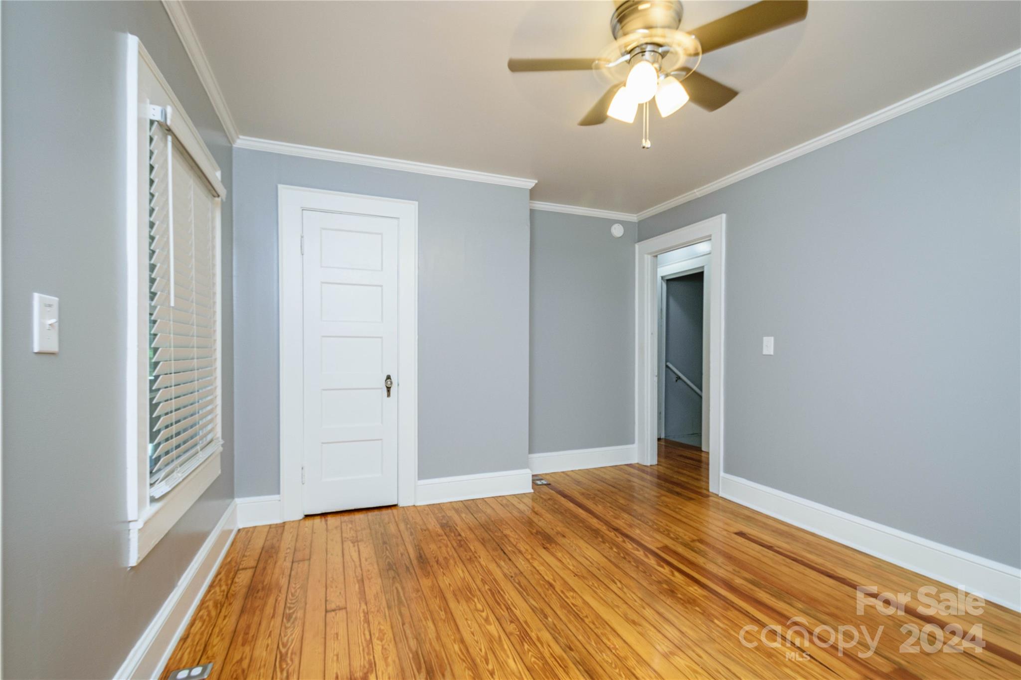 648 Chimney Rock Road Rutherfordton, NC 28139 - Photo 16 of 43 a view of empty room with wooden floor and fan