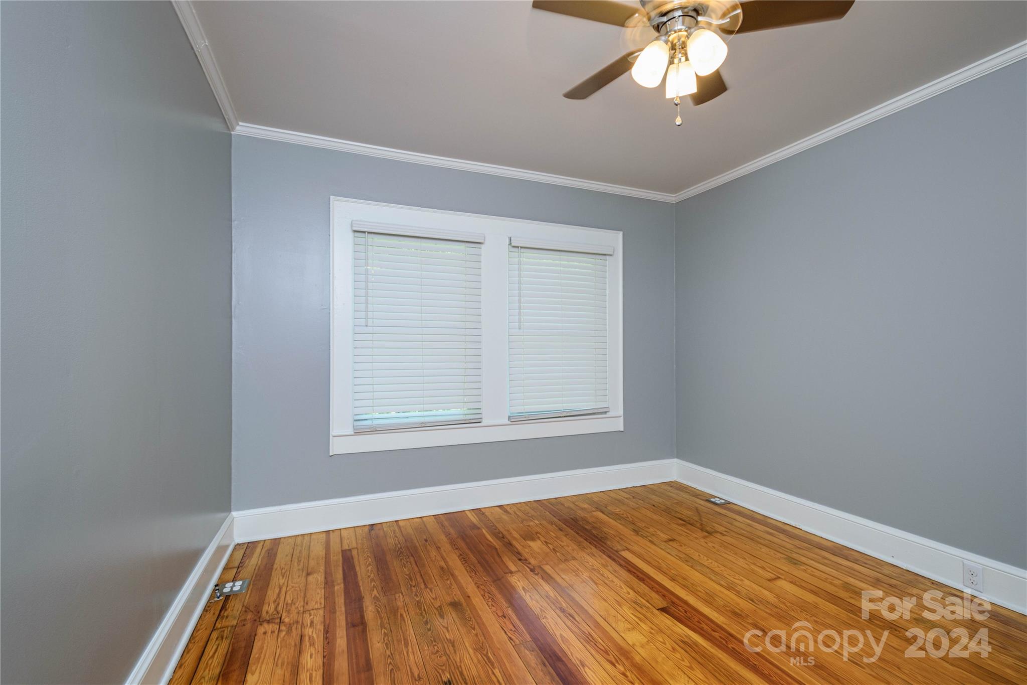 648 Chimney Rock Road Rutherfordton, NC 28139 - Photo 20 of 43 a view of an empty room with wooden floor and a window