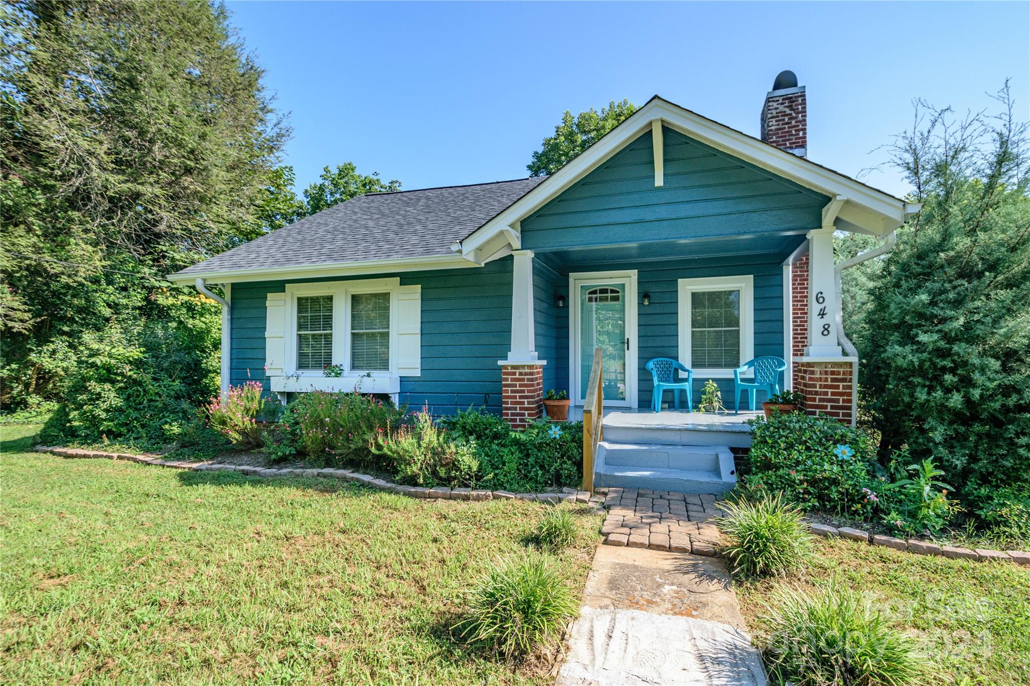 648 Chimney Rock Road Rutherfordton, NC 28139 - Photo 2 of 43 a front view of a house with garden