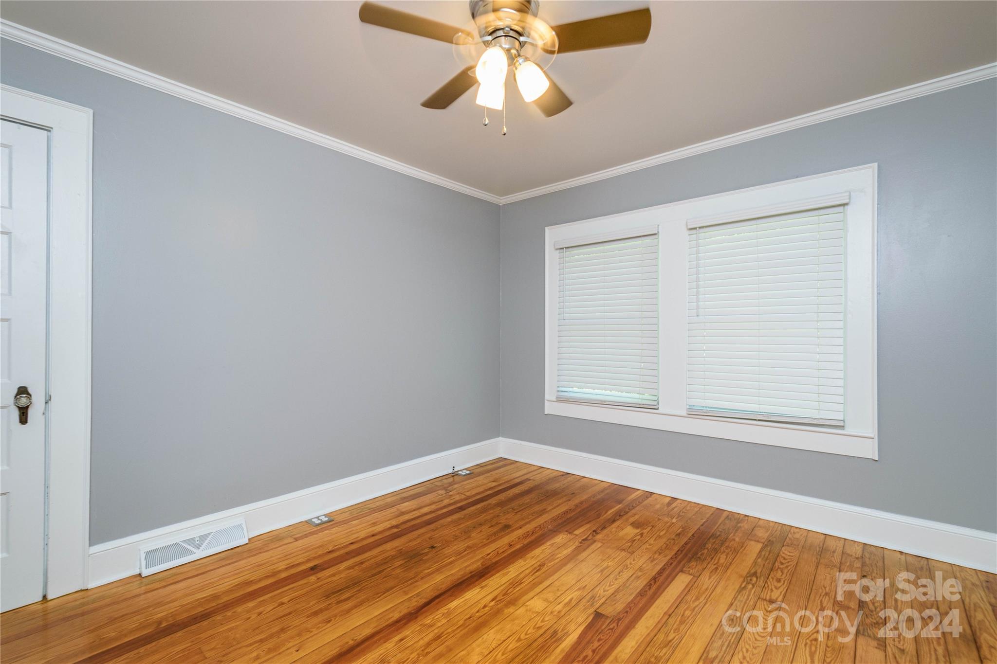 648 Chimney Rock Road Rutherfordton, NC 28139 - Photo 23 of 43 a view of an empty room with wooden floor and a window