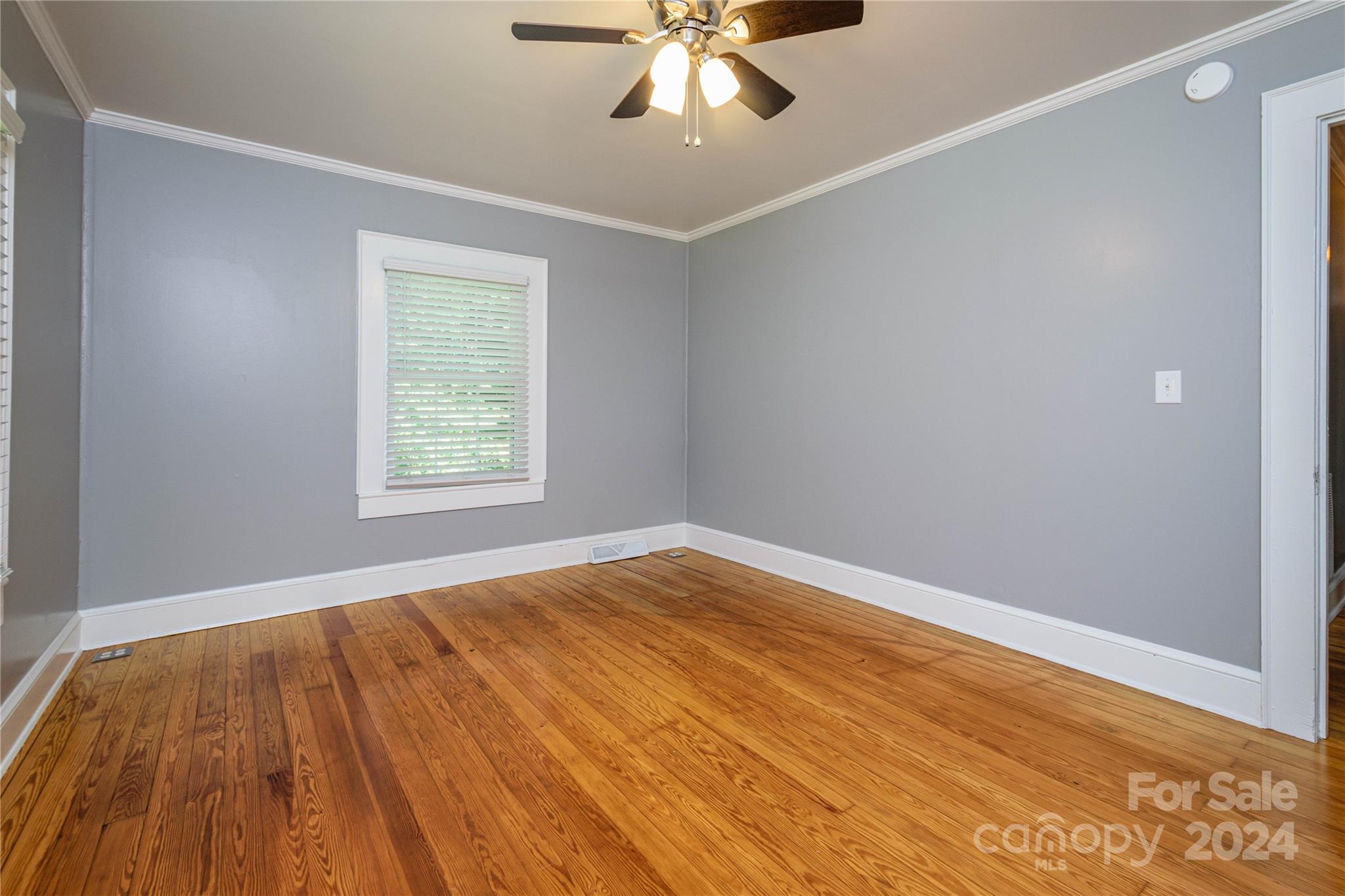 648 Chimney Rock Road Rutherfordton, NC 28139 - Photo 26 of 43 a view of an empty room with wooden floor and a window