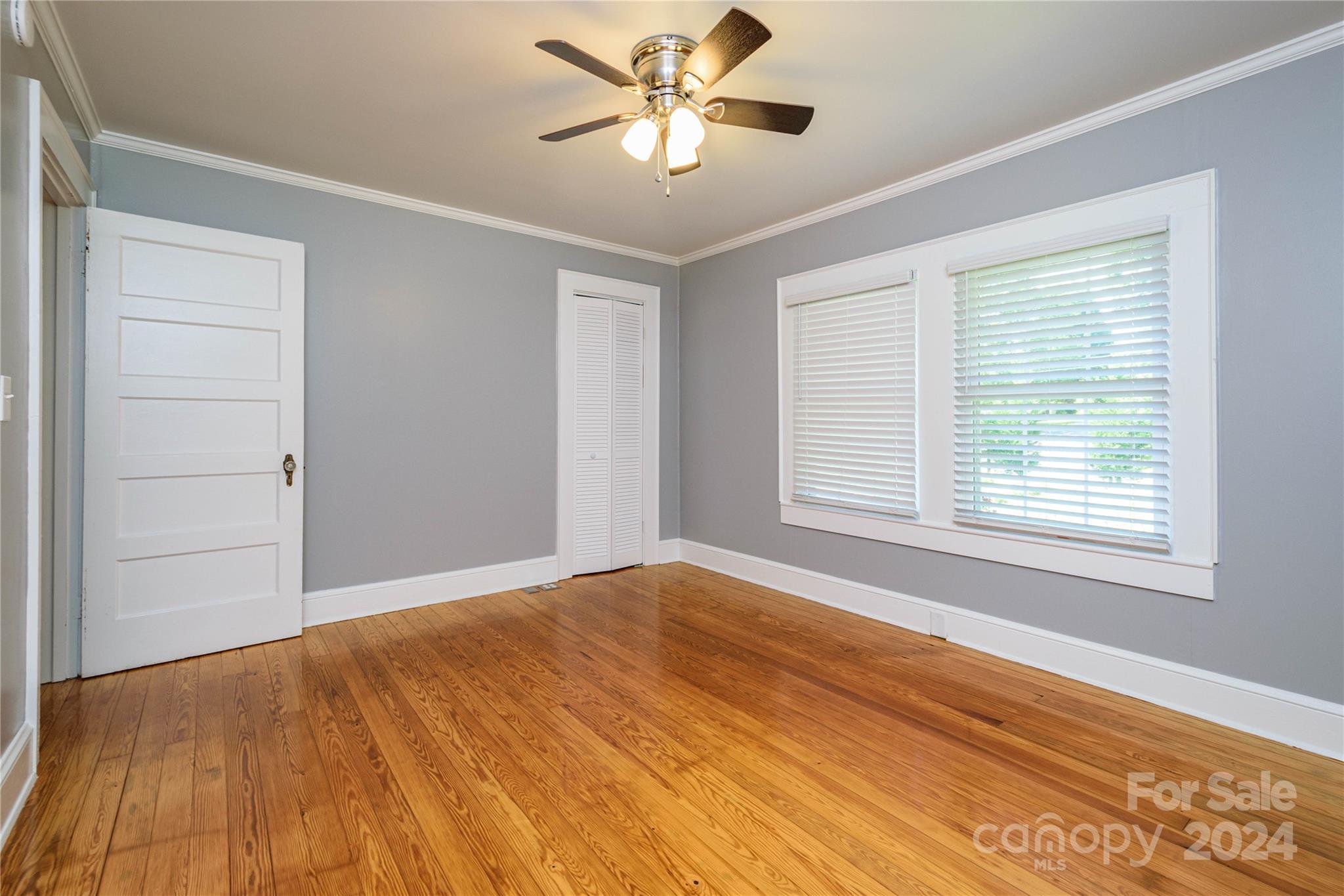 648 Chimney Rock Road Rutherfordton, NC 28139 - Photo 28 of 43 a view of a big room with wooden floor and a chandelier fan