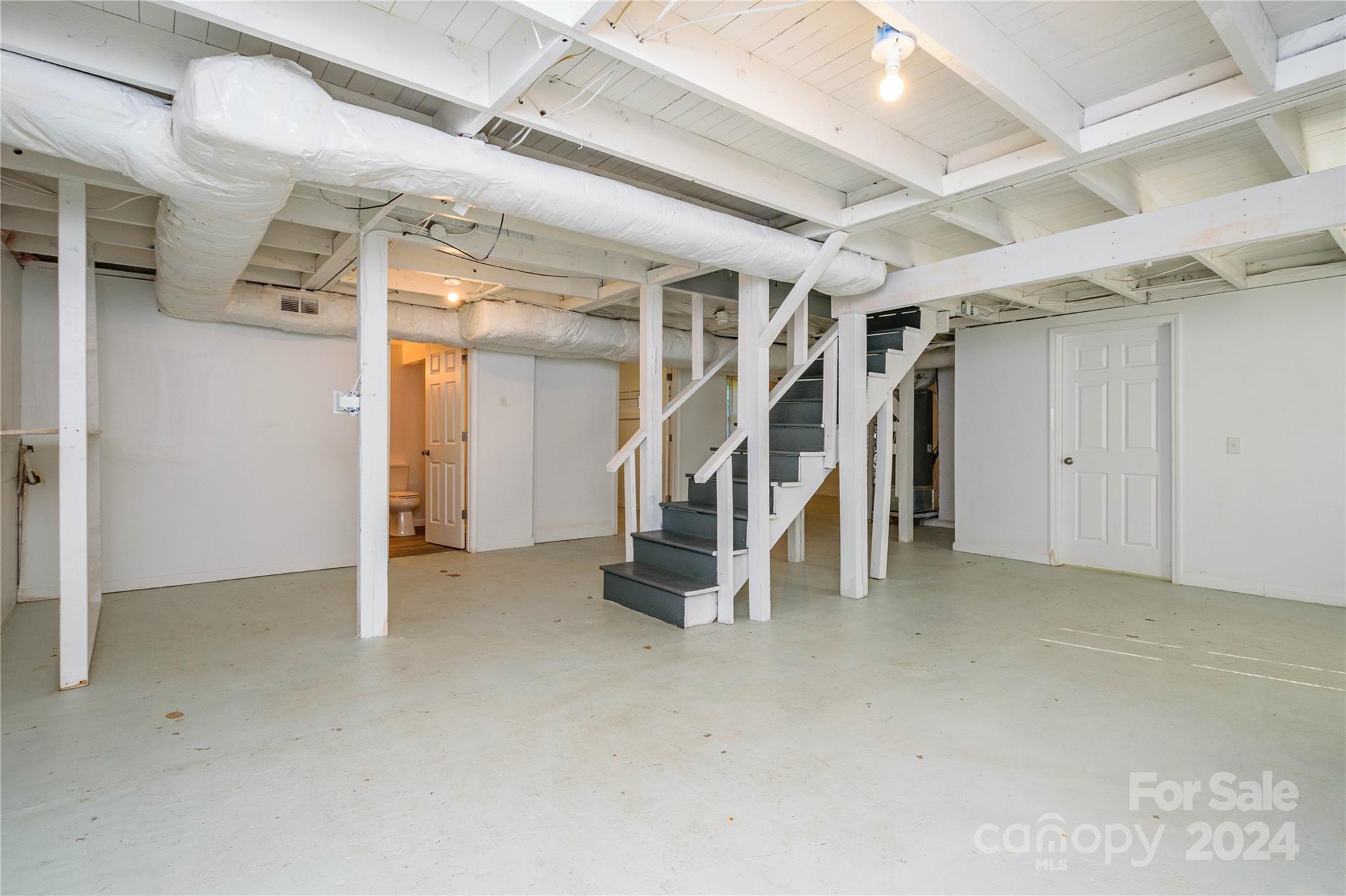 648 Chimney Rock Road Rutherfordton, NC 28139 - Photo 29 of 43 an empty room with white walls and stairs