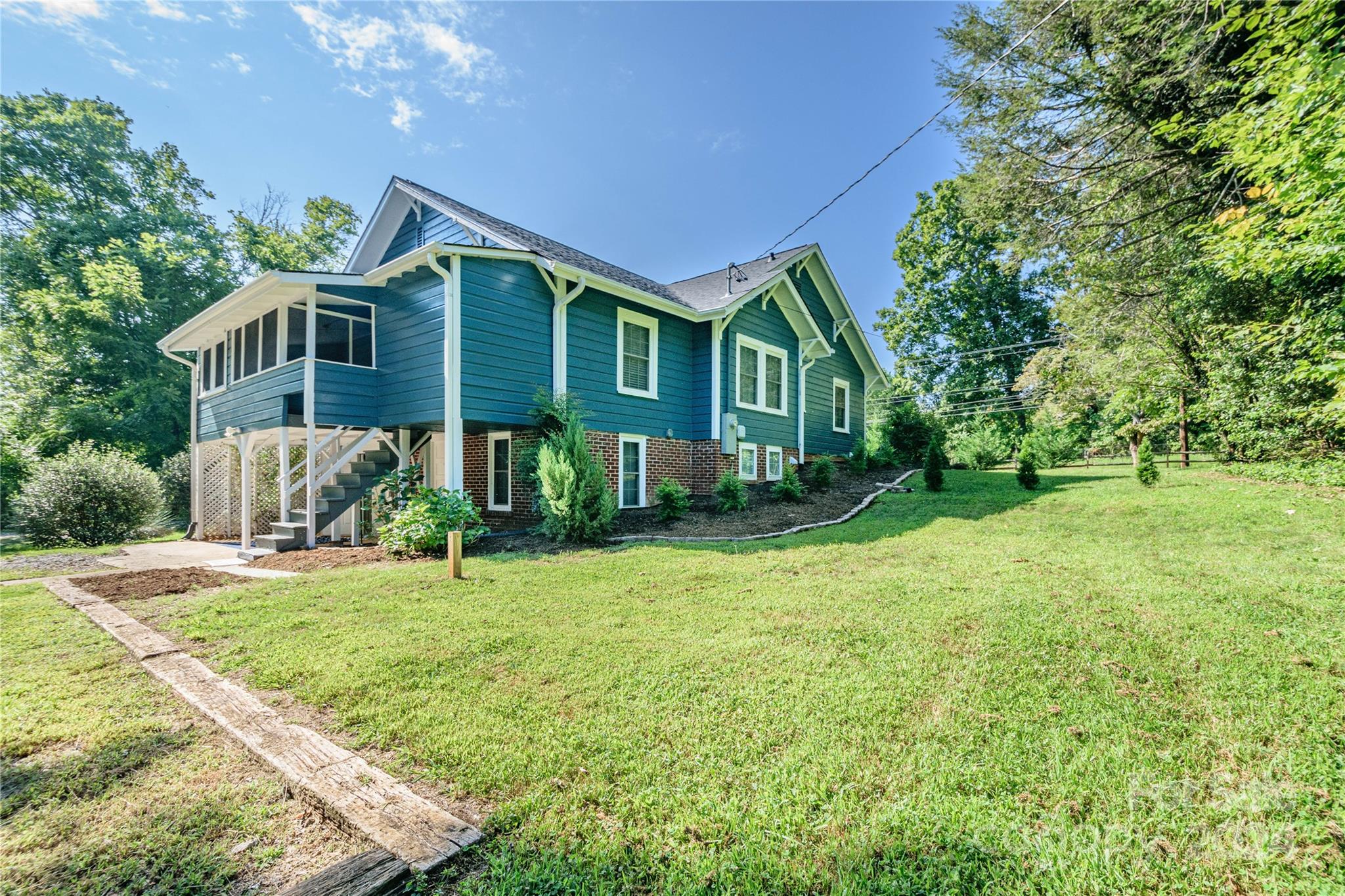 648 Chimney Rock Road Rutherfordton, NC 28139 - Photo 39 of 43 a front view of a house with yard and green space