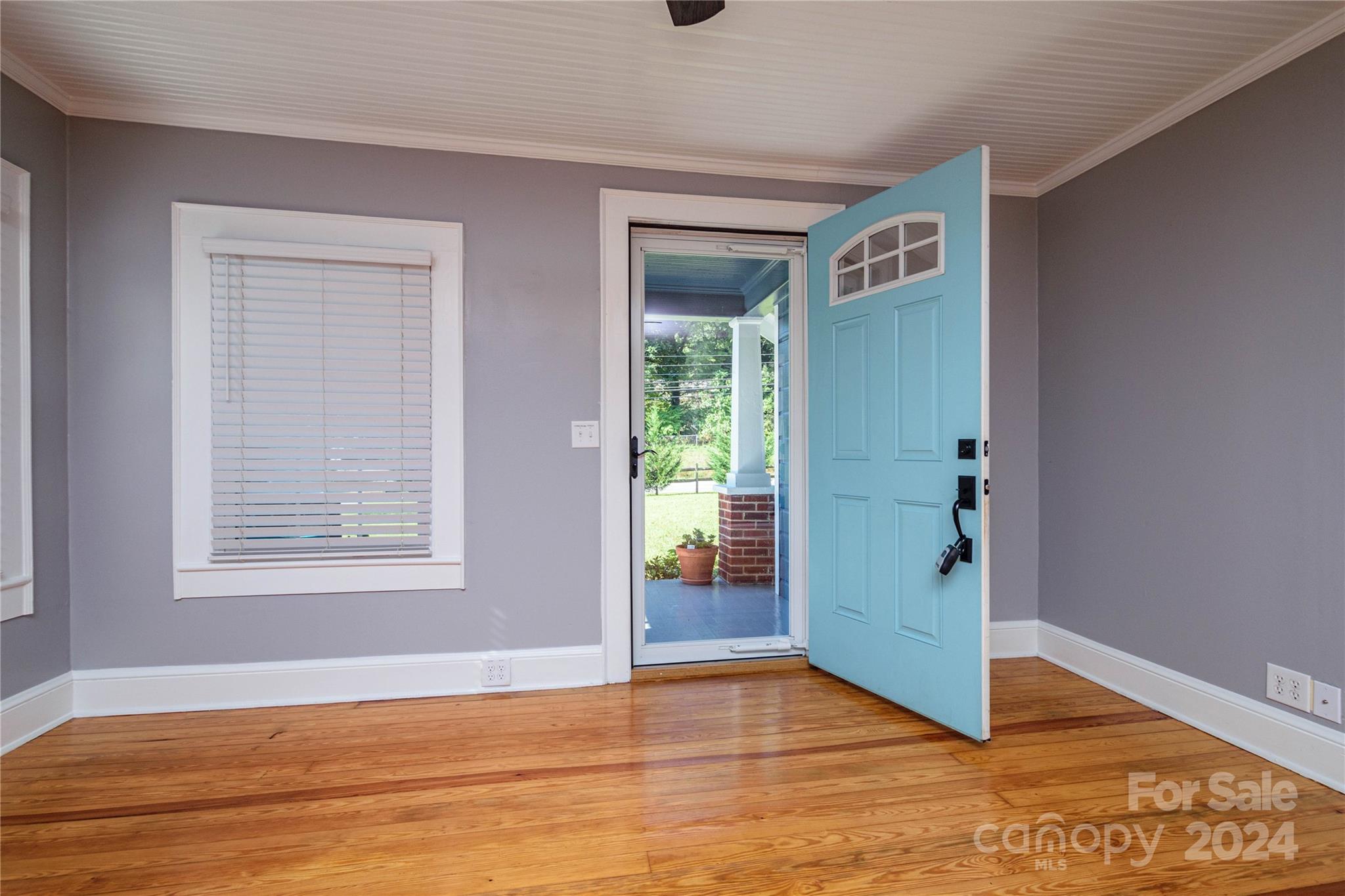 648 Chimney Rock Road Rutherfordton, NC 28139 - Photo 4 of 43 an empty room with wooden floor and windows