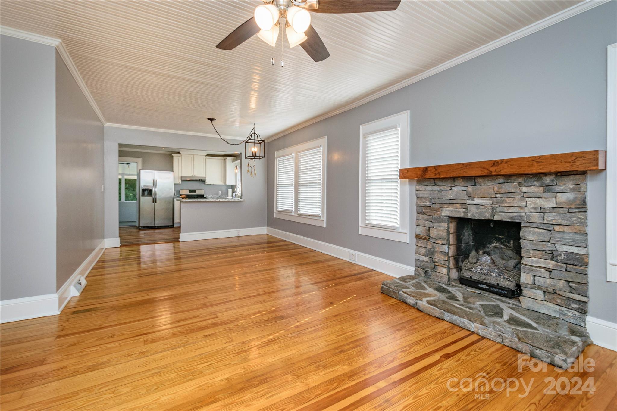 648 Chimney Rock Road Rutherfordton, NC 28139 - Photo 5 of 43 a view of a livingroom with a fireplace a chandelier and wooden floor