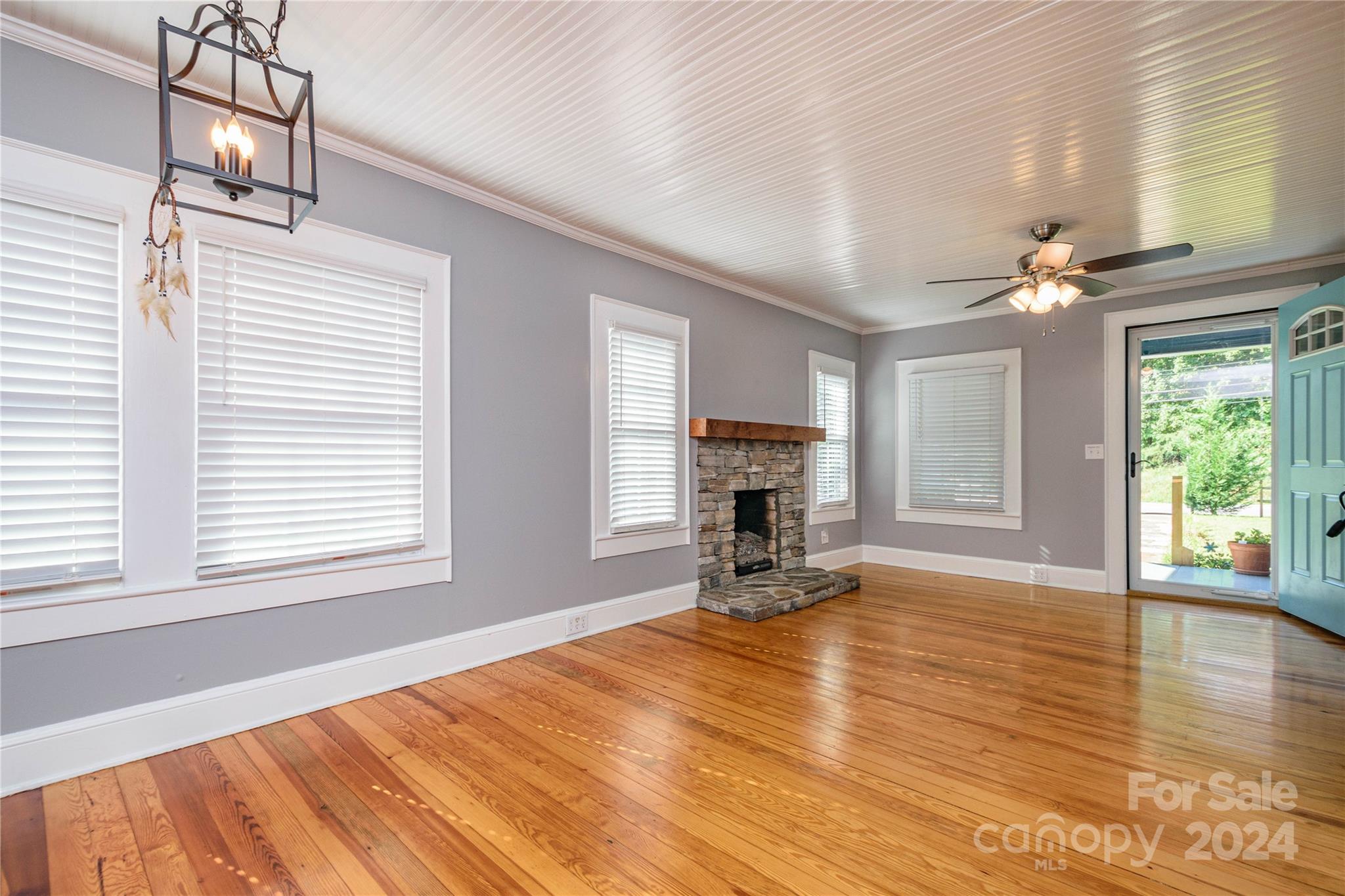 648 Chimney Rock Road Rutherfordton, NC 28139 - Photo 8 of 43 a view of empty room with wooden floor and fireplace