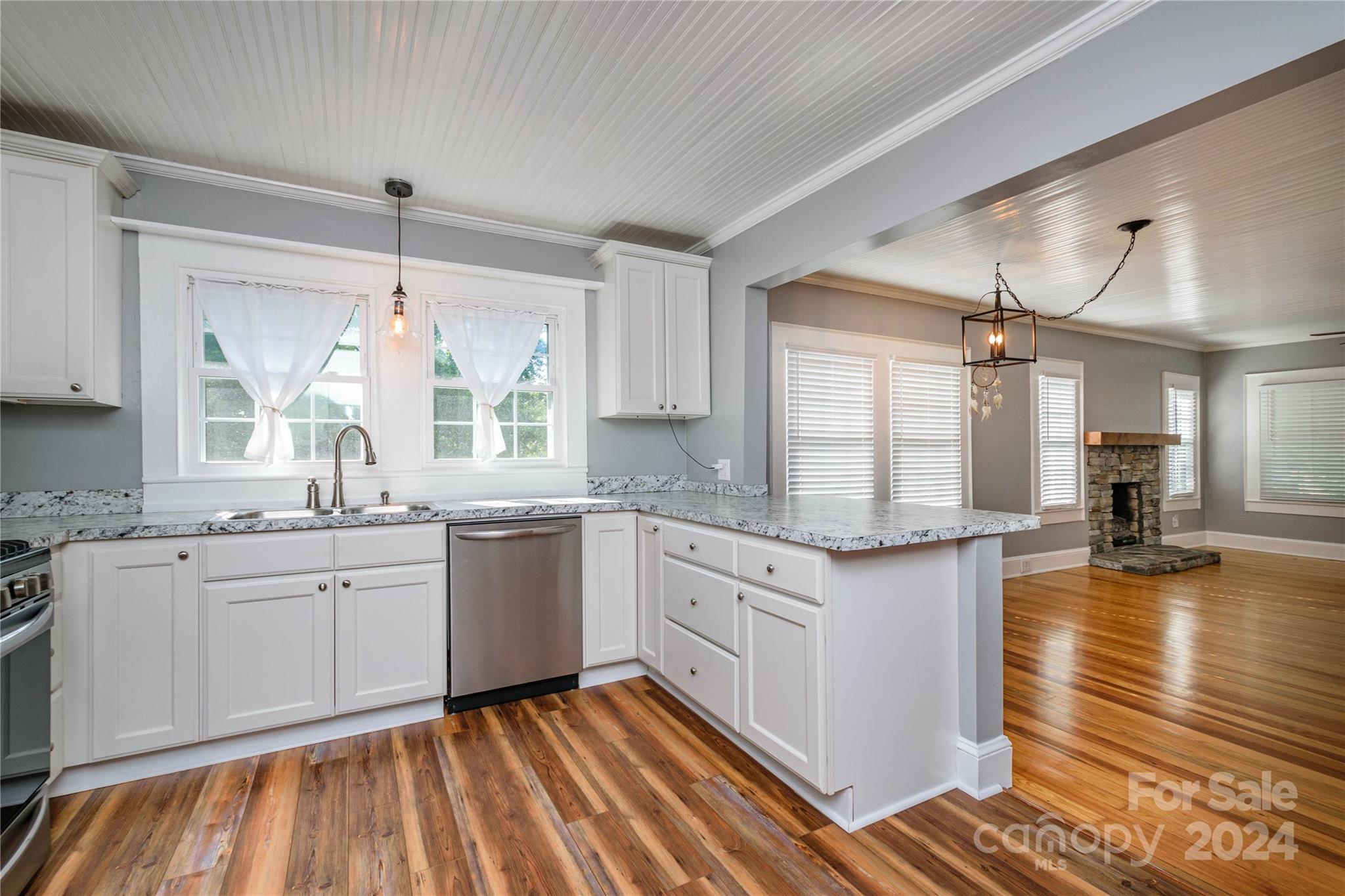 648 Chimney Rock Road Rutherfordton, NC 28139 - Photo 10 of 43 a kitchen with granite countertop white cabinets stainless steel appliances a sink and a window