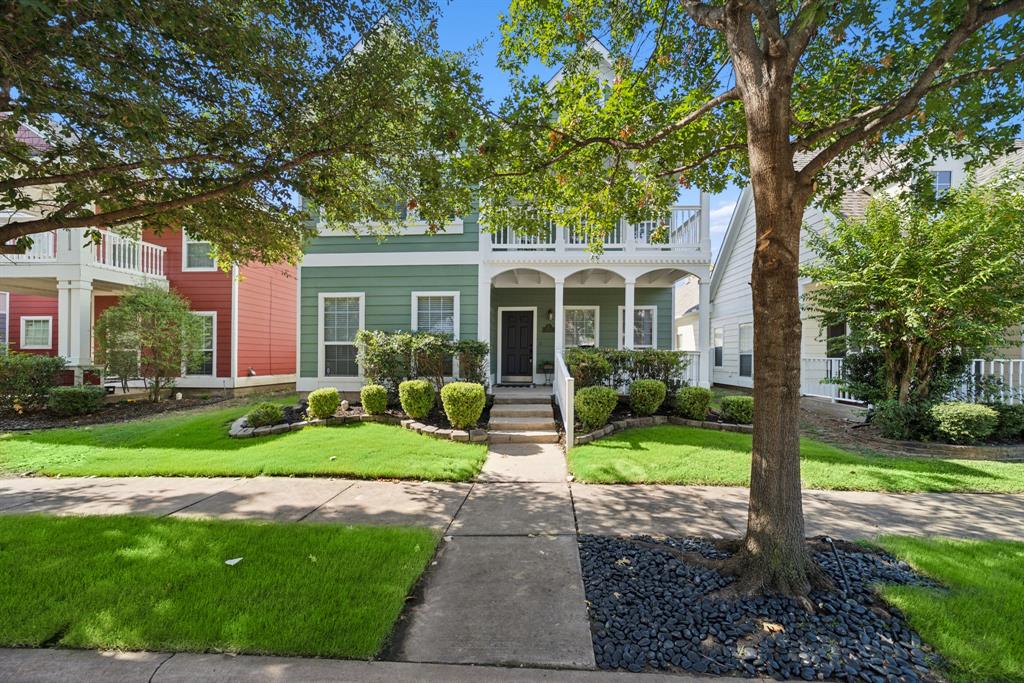 View of front of house featuring covered porch and a front lawn.