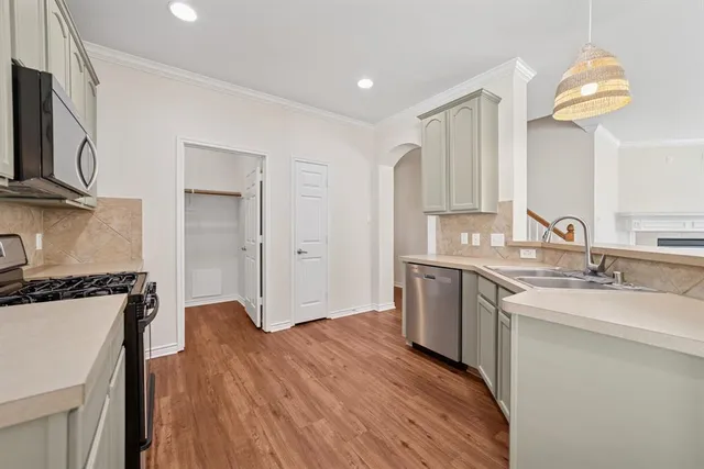 a view of a room with wooden floor and a window