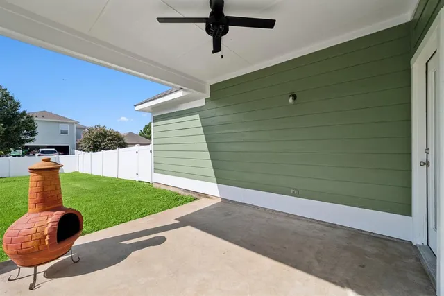 a view of a house with a yard and potted plants