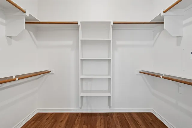 a view of walk in closet with empty racks