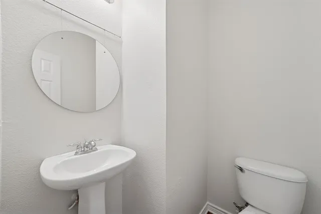 a bathroom with a sink a mirror and a toilet