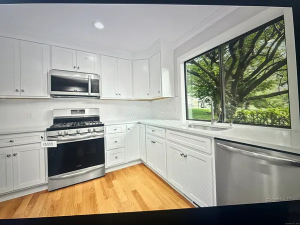 a kitchen with a stove a sink and a microwave