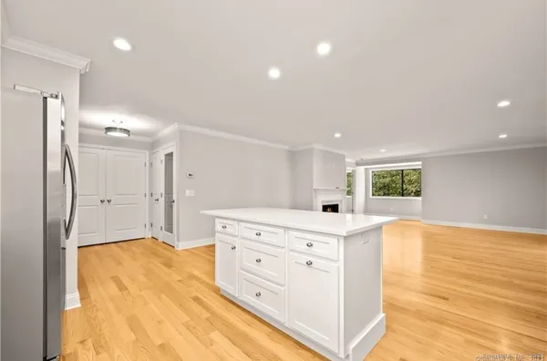 a view of a livingroom with wooden floor and a fireplace