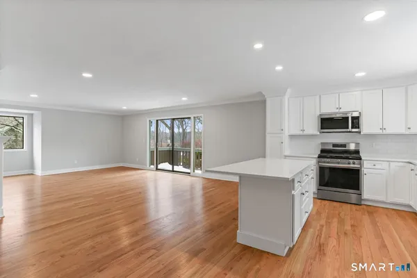 a kitchen with a sink stove top oven and refrigerator