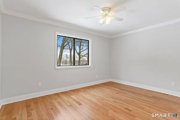 a view of an empty room with wooden floor