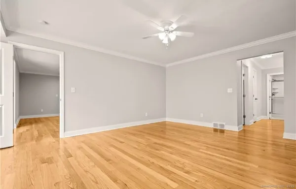 a view of an empty room and wooden floor