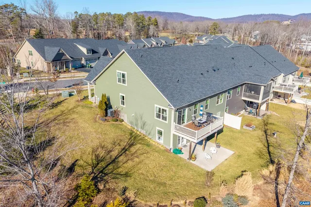 a kitchen with kitchen island granite countertop a stove a sink a dining table and chairs with wooden floor