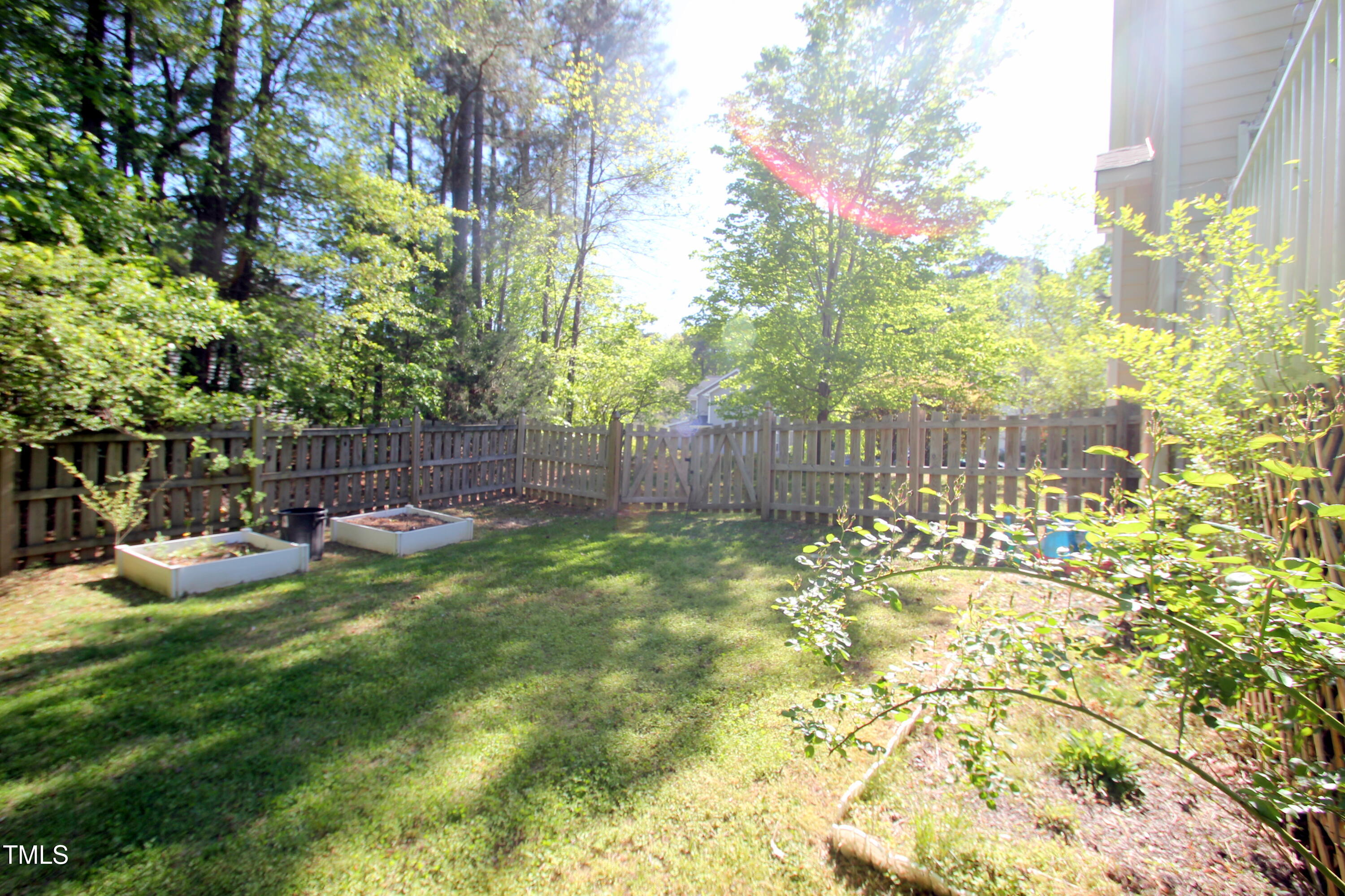 3219 Ranbir Drive Durham, NC 27713 - Photo 3 of 4 a view of backyard with table and chairs and large trees