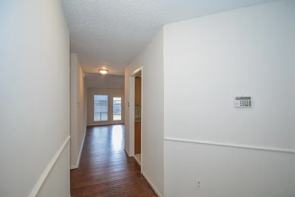 a view of a hallway with wooden floor