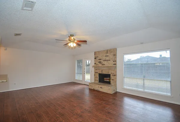 wooden floor in an empty room with a fireplace