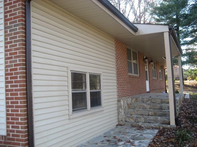 6206 Meacham Road Salem, VA 24153 - Photo 5 of 23 a view of a house with a large window and brick walls