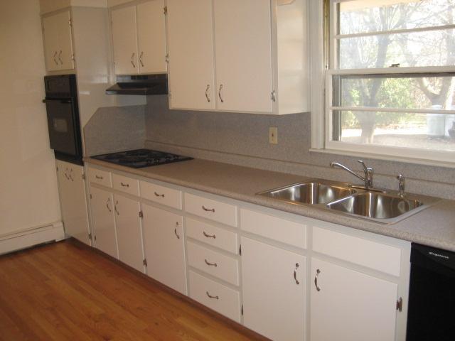 6206 Meacham Road Salem, VA 24153 - Photo 9 of 23 a kitchen with granite countertop white cabinets and sink