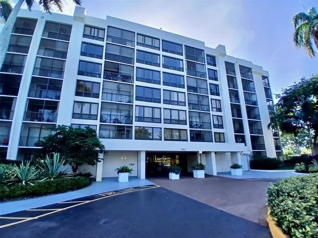 a front view of a building with a garden