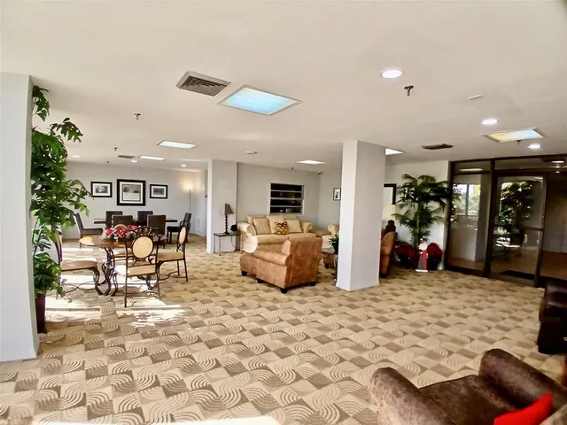 a view of a livingroom with furniture window and wooden floor