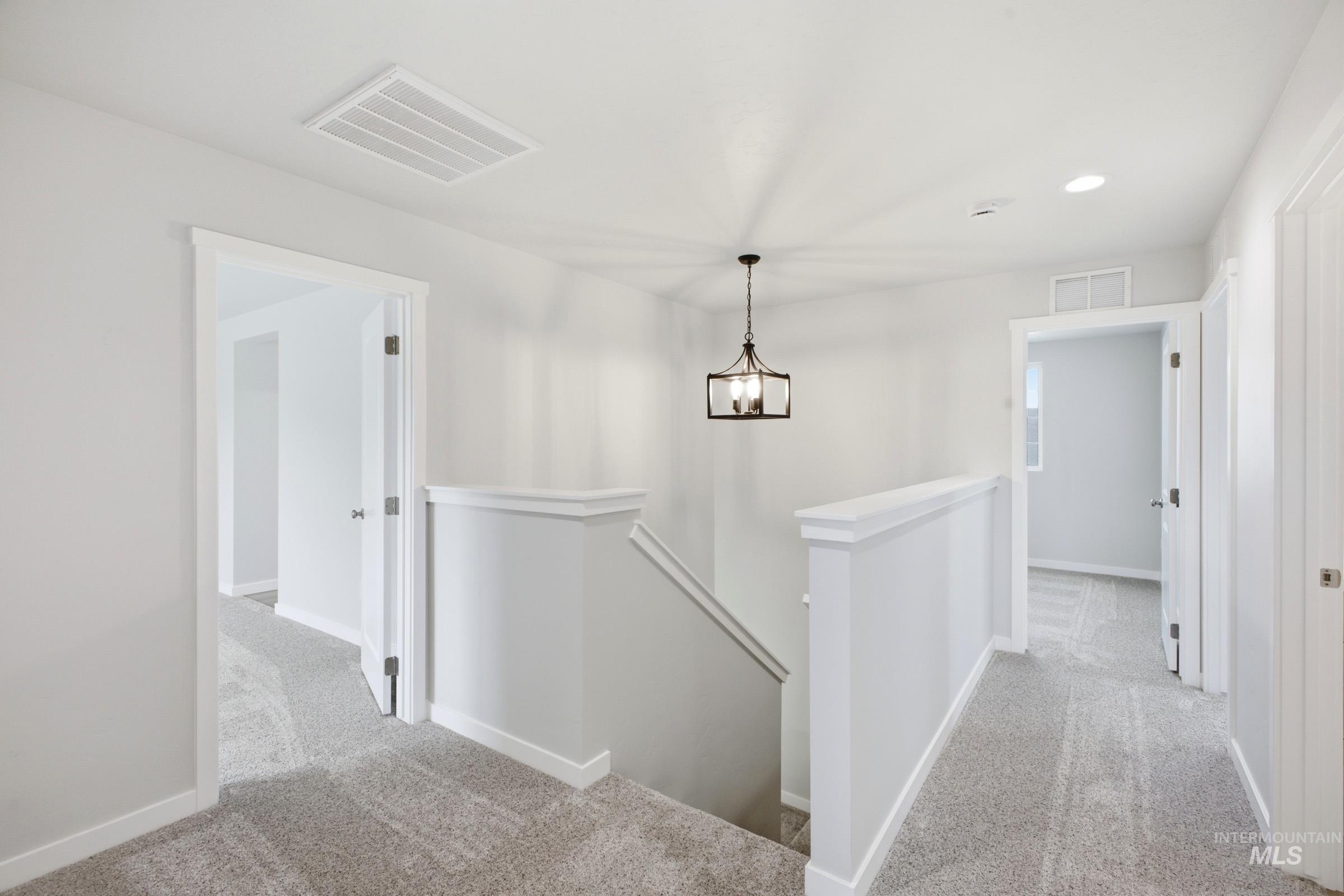13336 Bank Street Caldwell, ID 83607 - Photo 12 of 24 Staircase featuring a white painted railing, ceiling-mounted light fixture, and recessed lighting