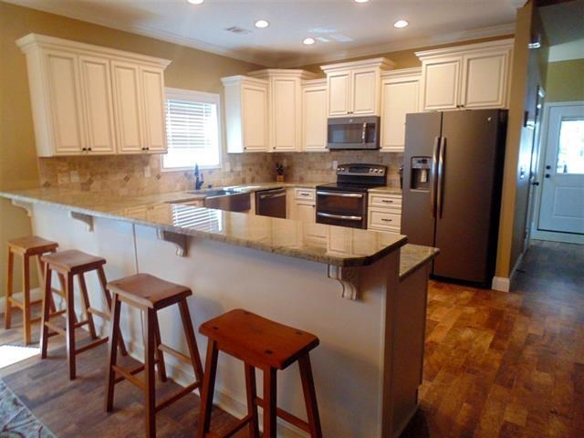 342 Duke Road Perry, GA 31069 - Photo 11 of 34 a kitchen with stainless steel appliances granite countertop a table chairs refrigerator and a sink