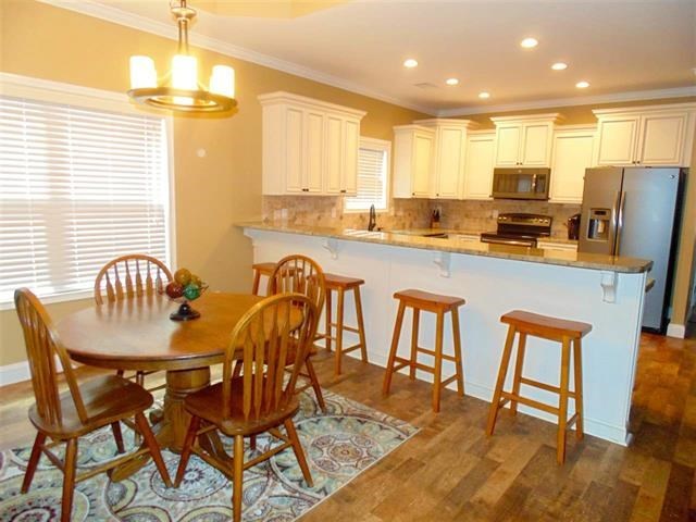 342 Duke Road Perry, GA 31069 - Photo 12 of 34 a kitchen with granite countertop a table chairs stove and refrigerator