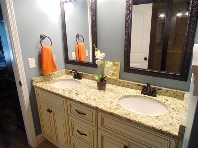 342 Duke Road Perry, GA 31069 - Photo 16 of 34 a bathroom with a granite countertop double vanity sink and a mirror